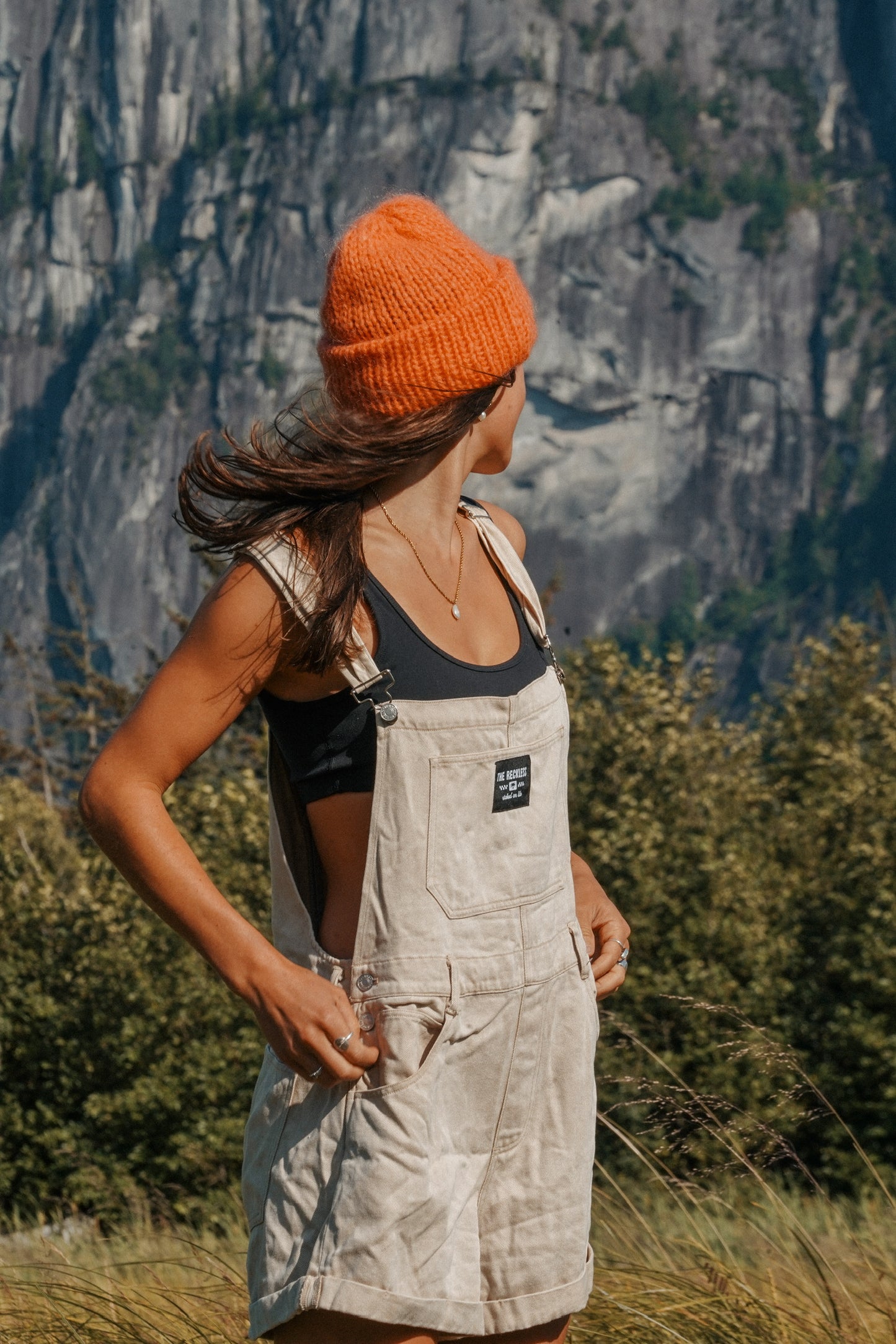Woman wearing cotton safari overalls in beige with relaxed fit and adjustable straps