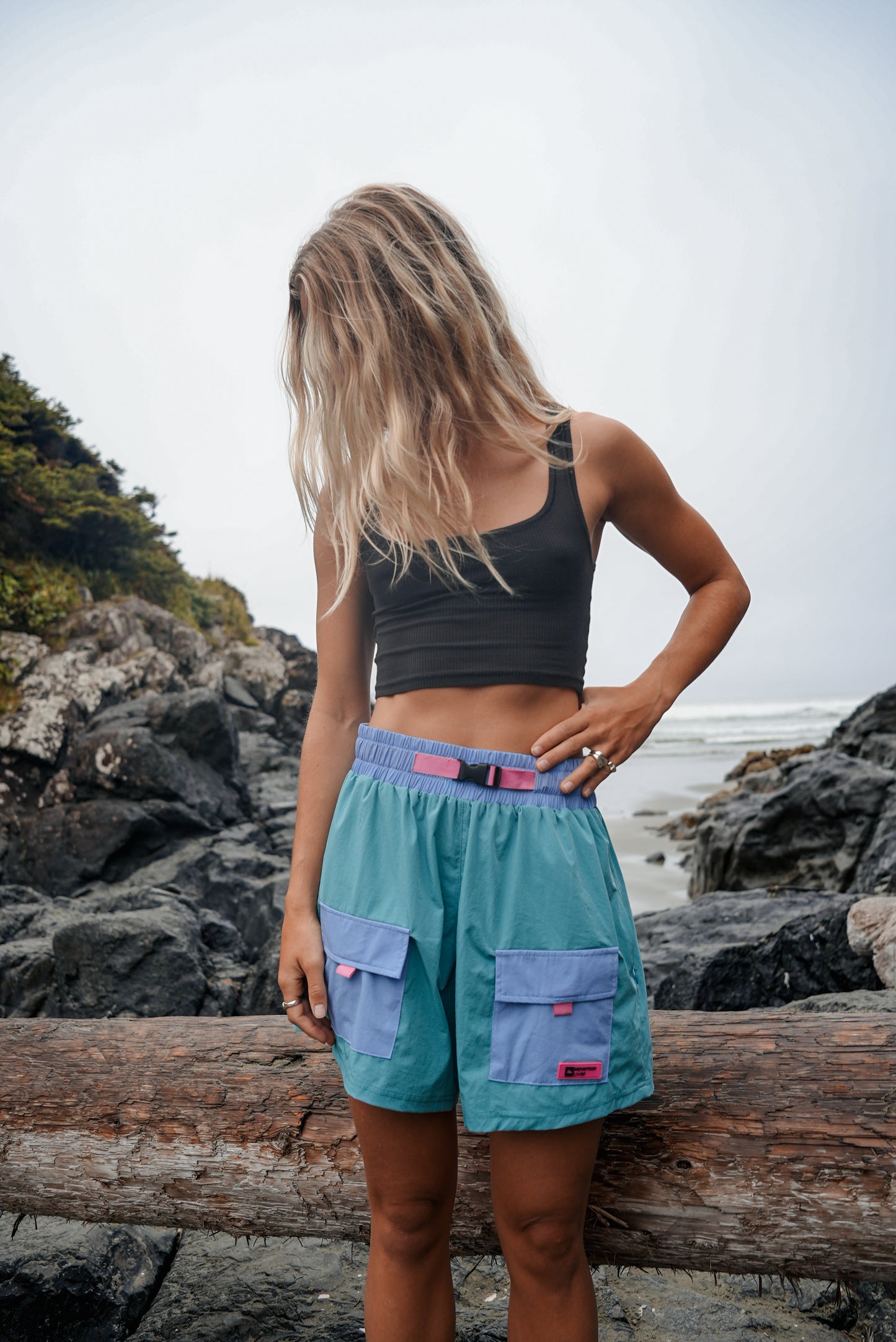 Woman wearing blue-green cotton Highland Trek shorts in a lightweight summer hiking style