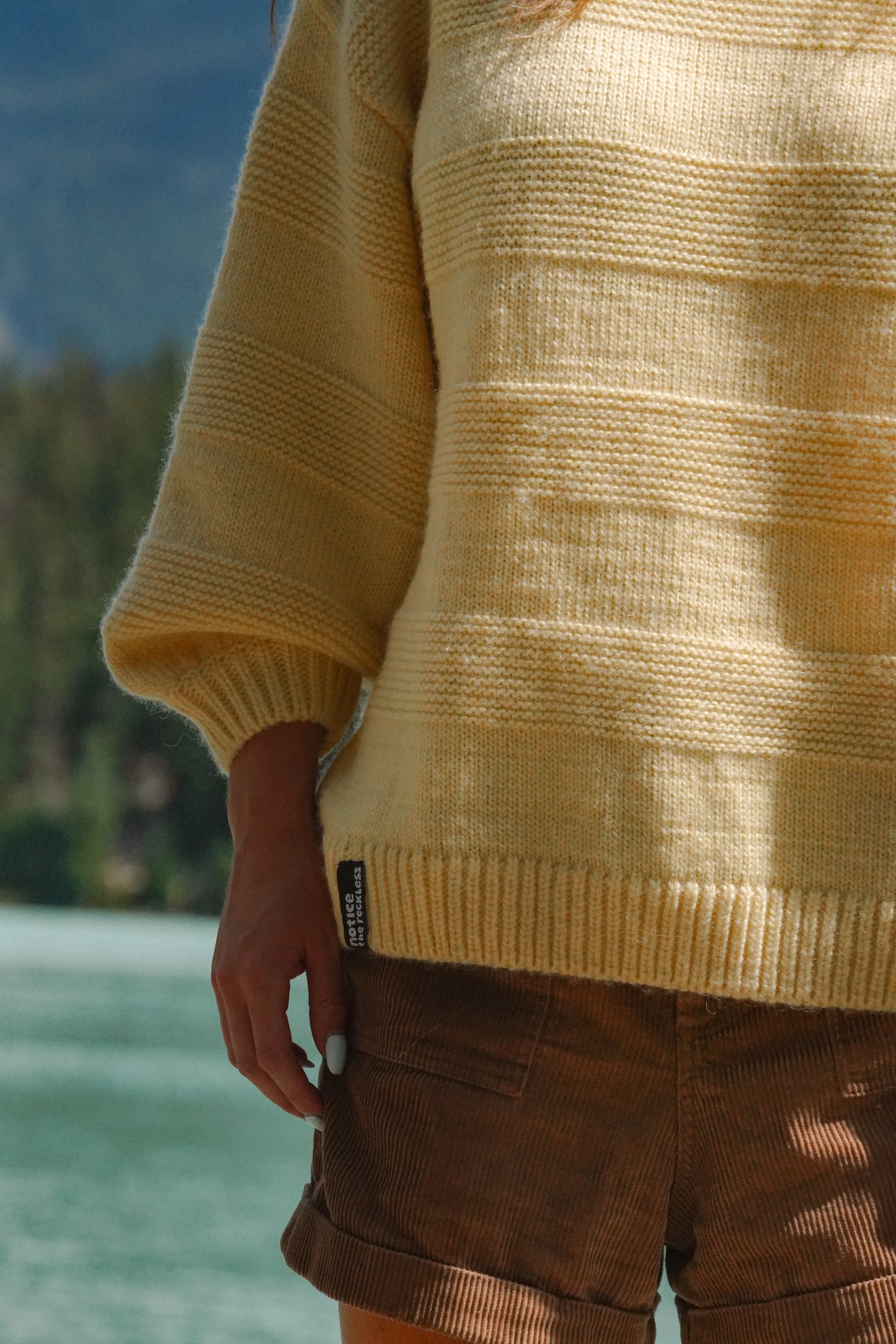 Textured butter yellow wool sweater with relaxed fit and statement sleeves