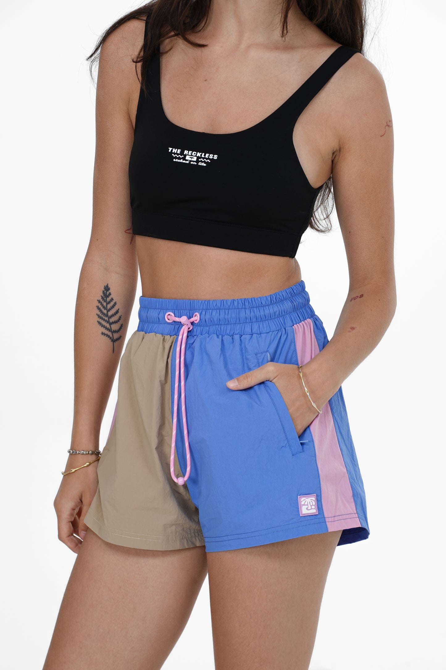 Women’s shorts with tan, blue, and pink design featuring elastic waist and side pockets