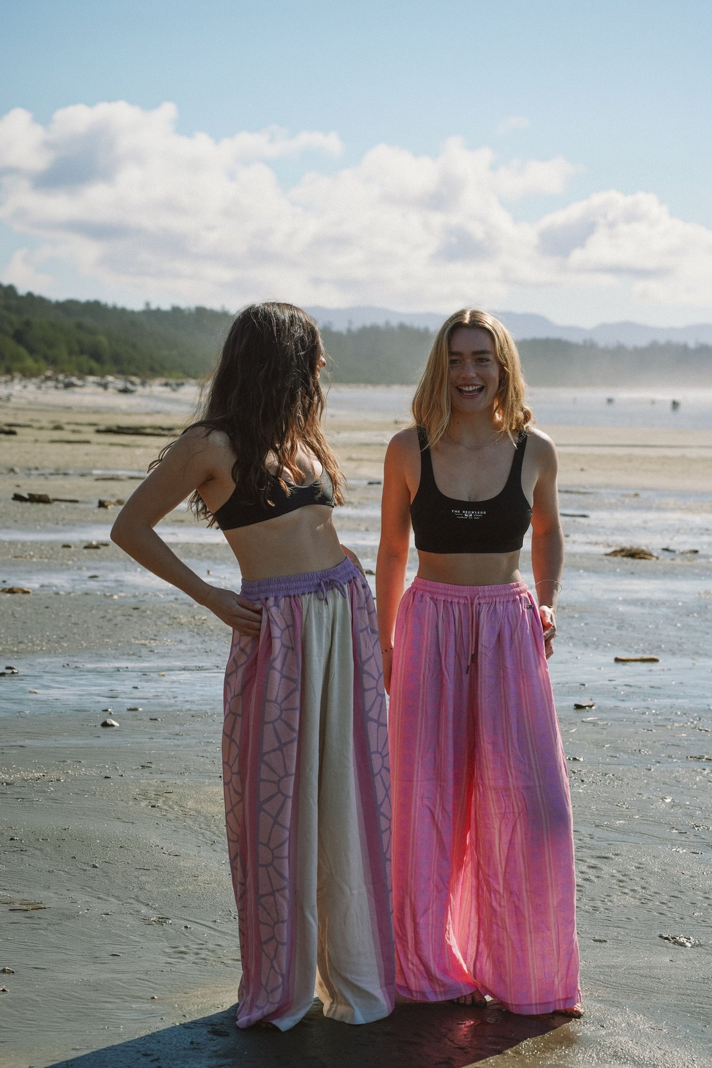 Woman wearing lightweight cotton boho pants with multicolor print in a relaxed summer surf look