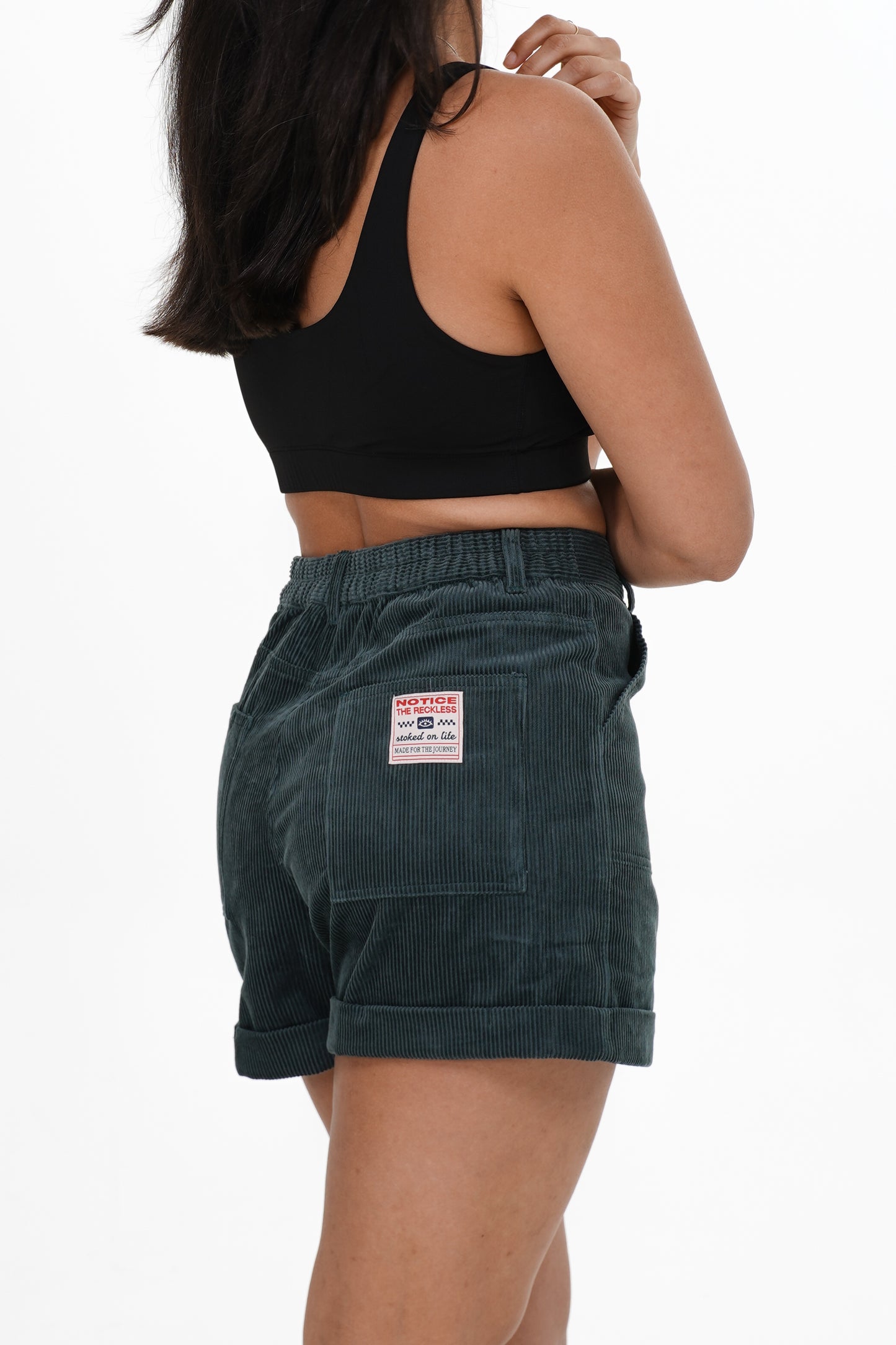Dark teal corduroy shorts with tailored fit and cuffed hem for casual summer wear