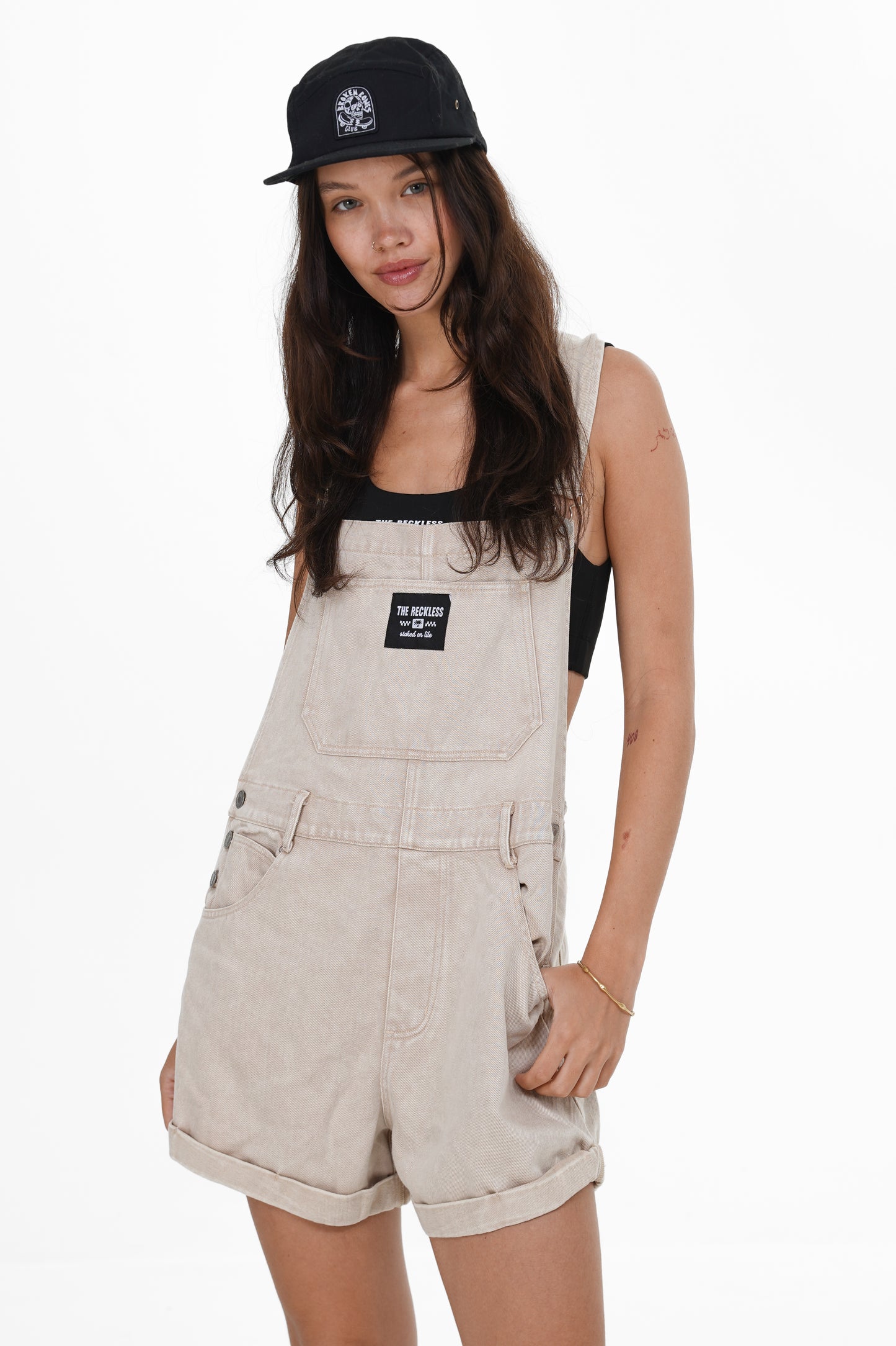Beige cotton overalls with adjustable suspenders and casual summer look