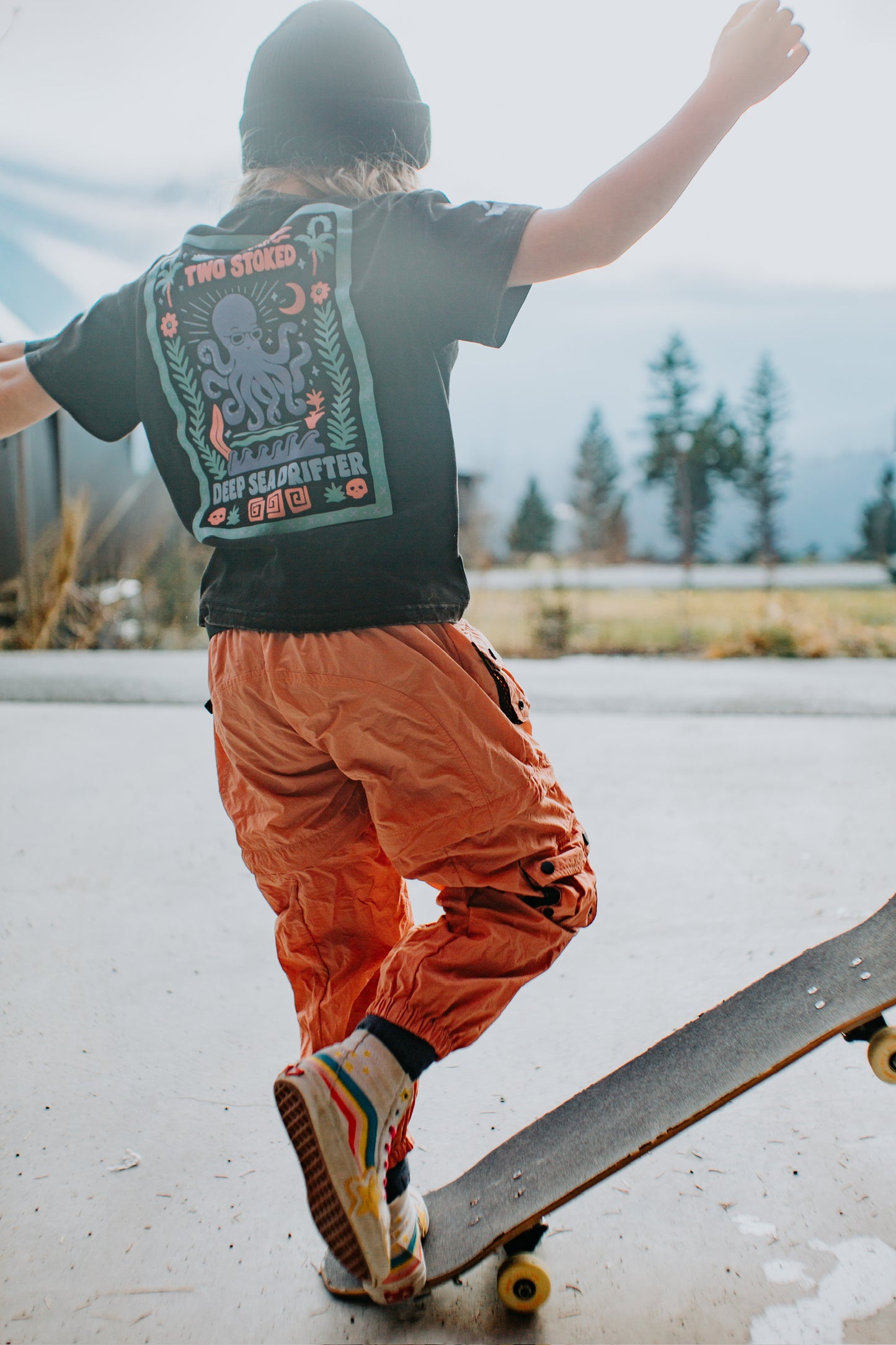 Kids dusty coral hiking pants with cargo pockets designed for outdoor adventures