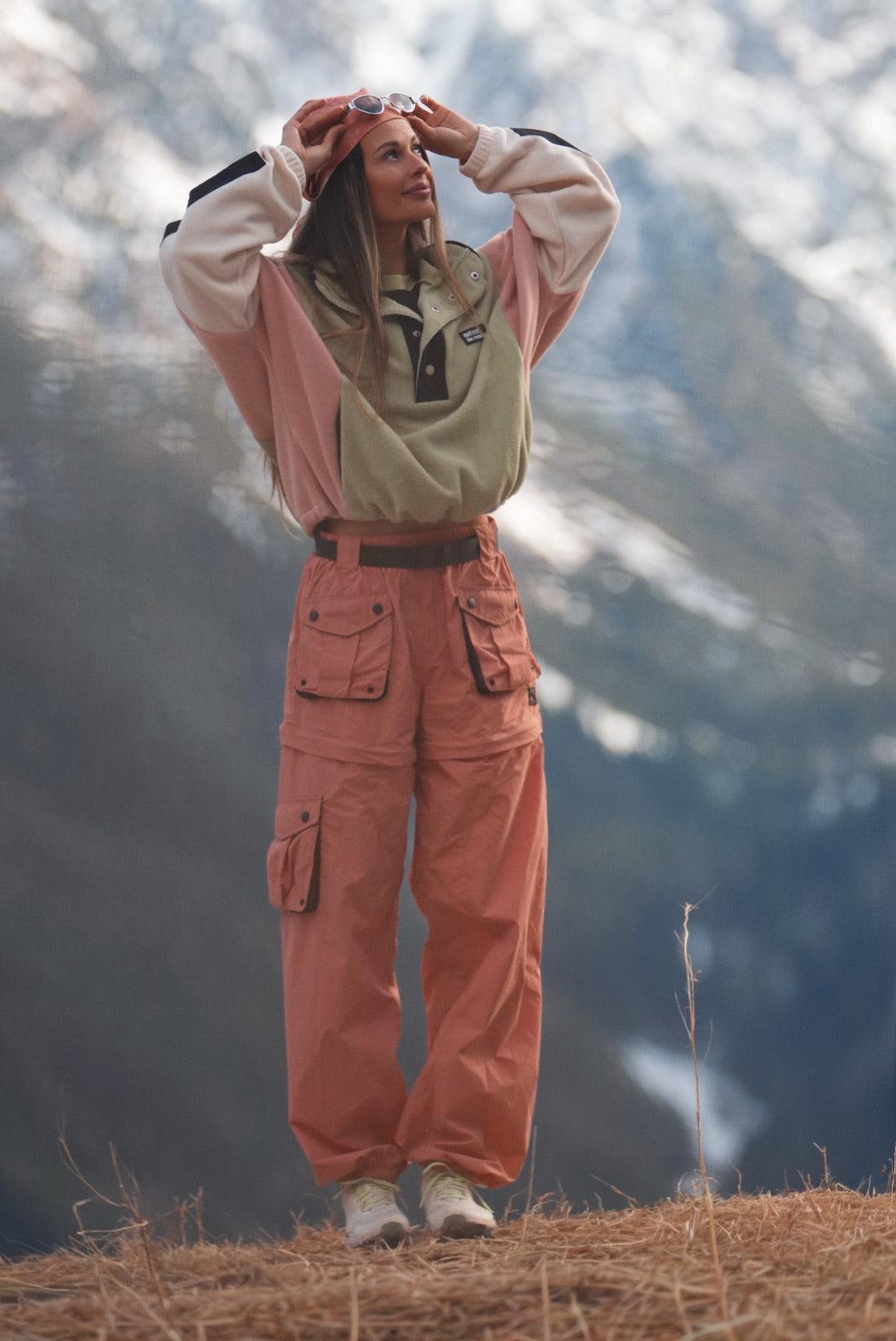 Women's dusty coral convertible hiking pants with zip-off legs worn outdoors