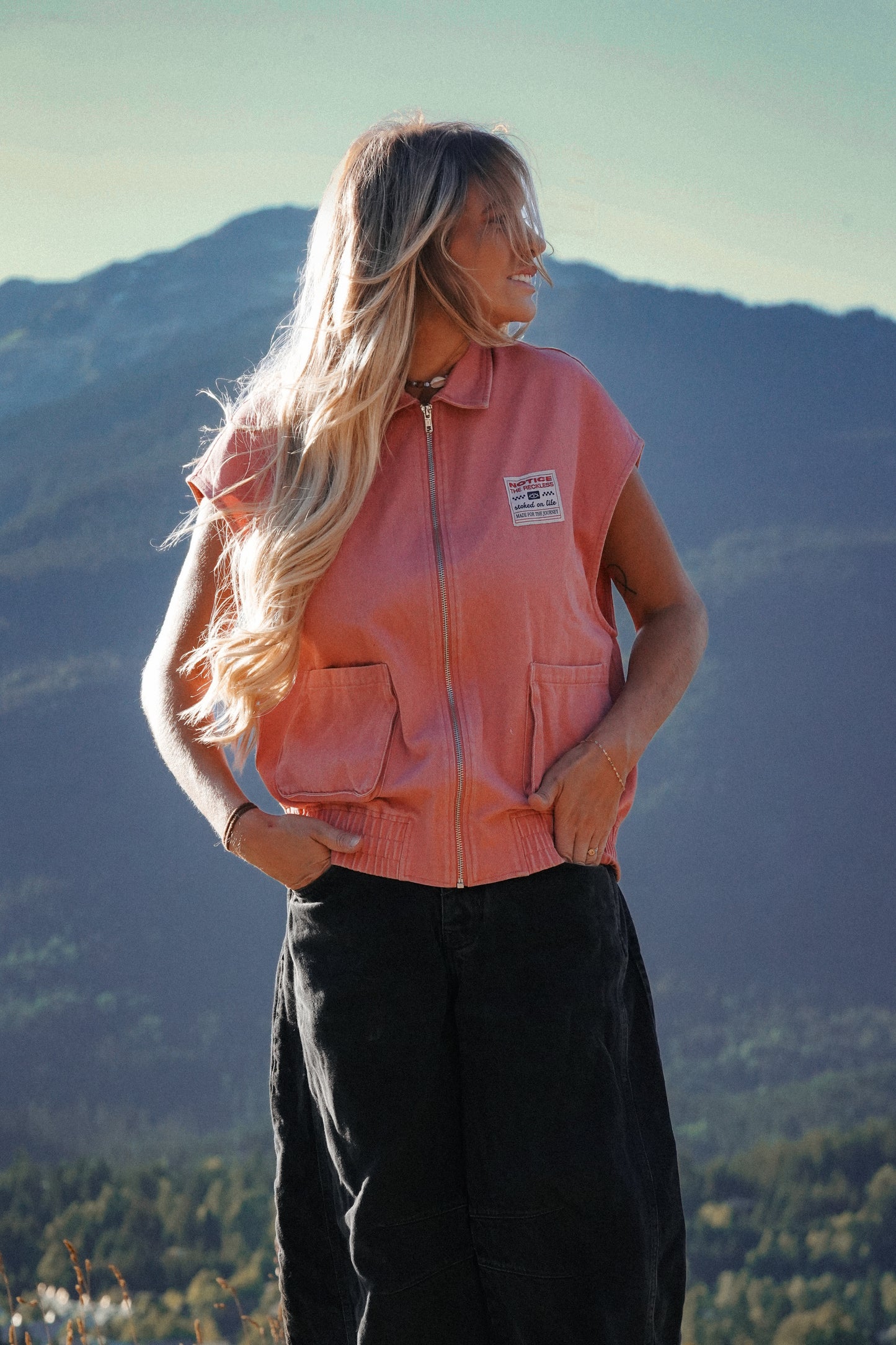 Women’s sleeveless jeans vest in dusty pink with large pockets and relaxed fit