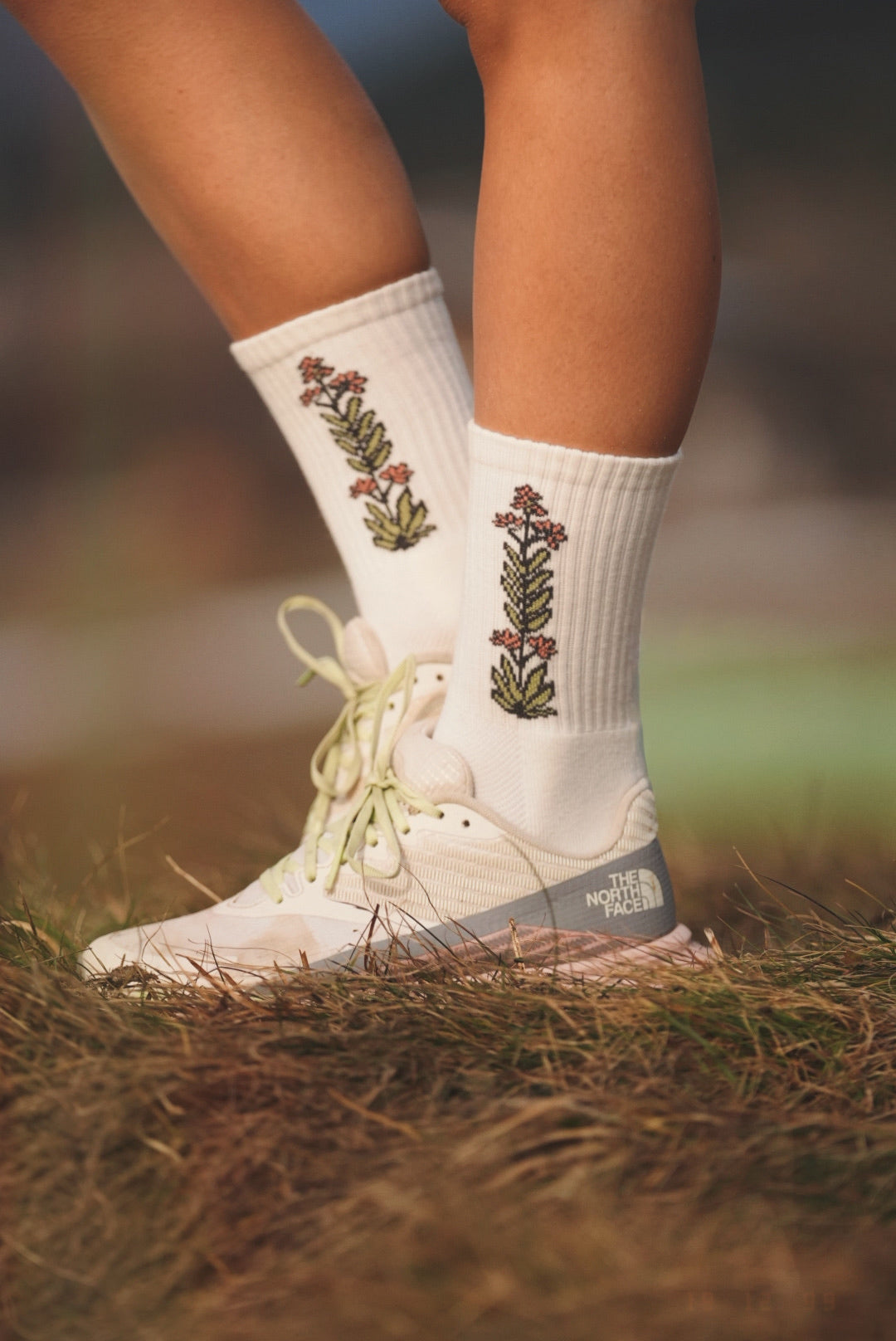 White merino wool hiking socks with embroidered flower and mushroom designs