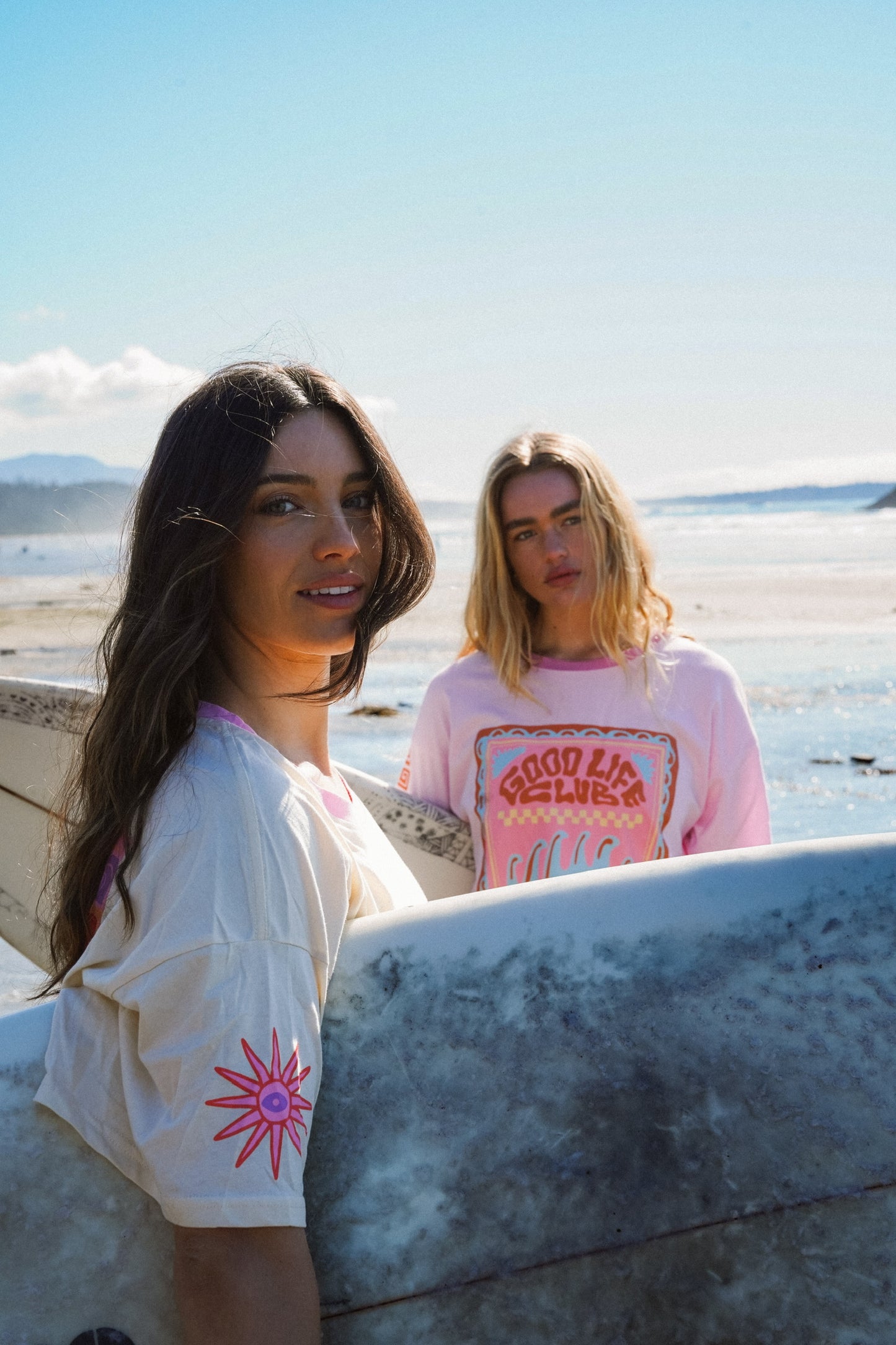 Woman wearing ivory cotton oversized tee with Stay Salty print at the beach in summer