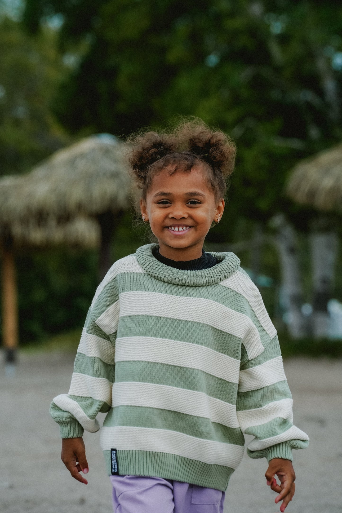 Chunky knit kids sweater in sage and cream stripes, made from 100% cotton for everyday wear
