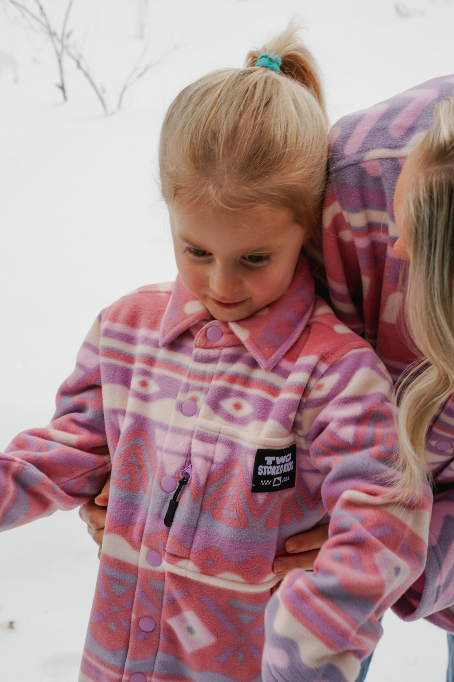 Kids fleece overshirt in pink tones with zip chest pocket and hand pockets