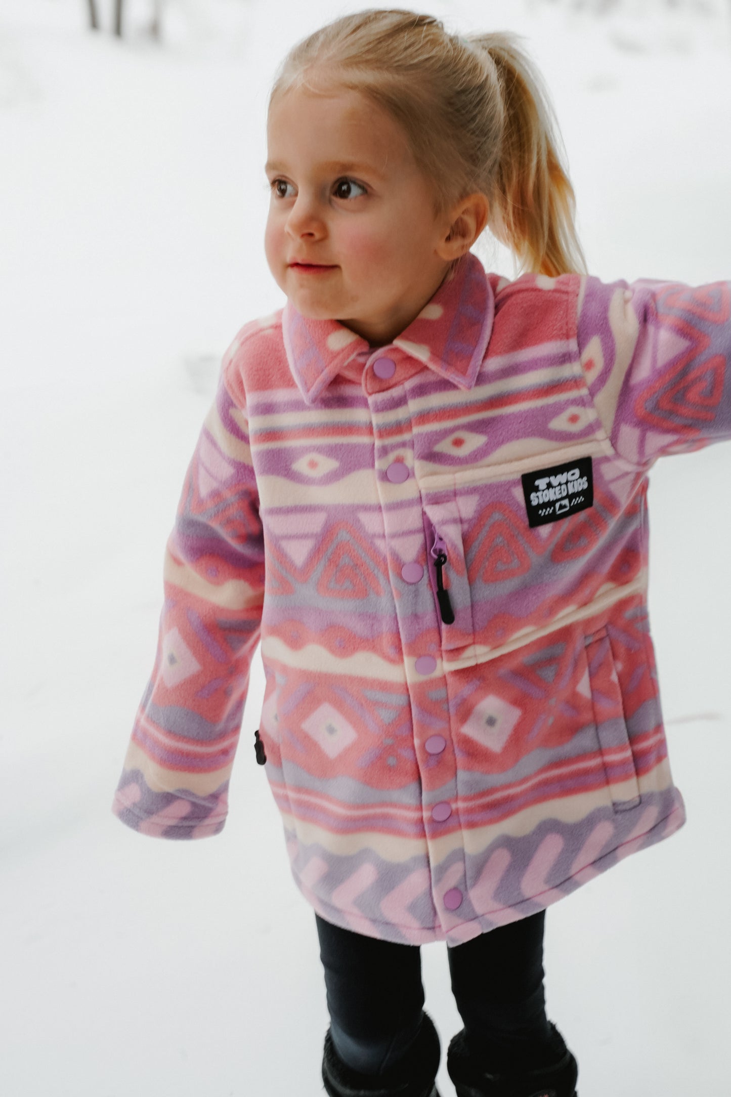 Pink and purple kids fleece shirt with snap front closure and zip chest pocket, made for everyday wear