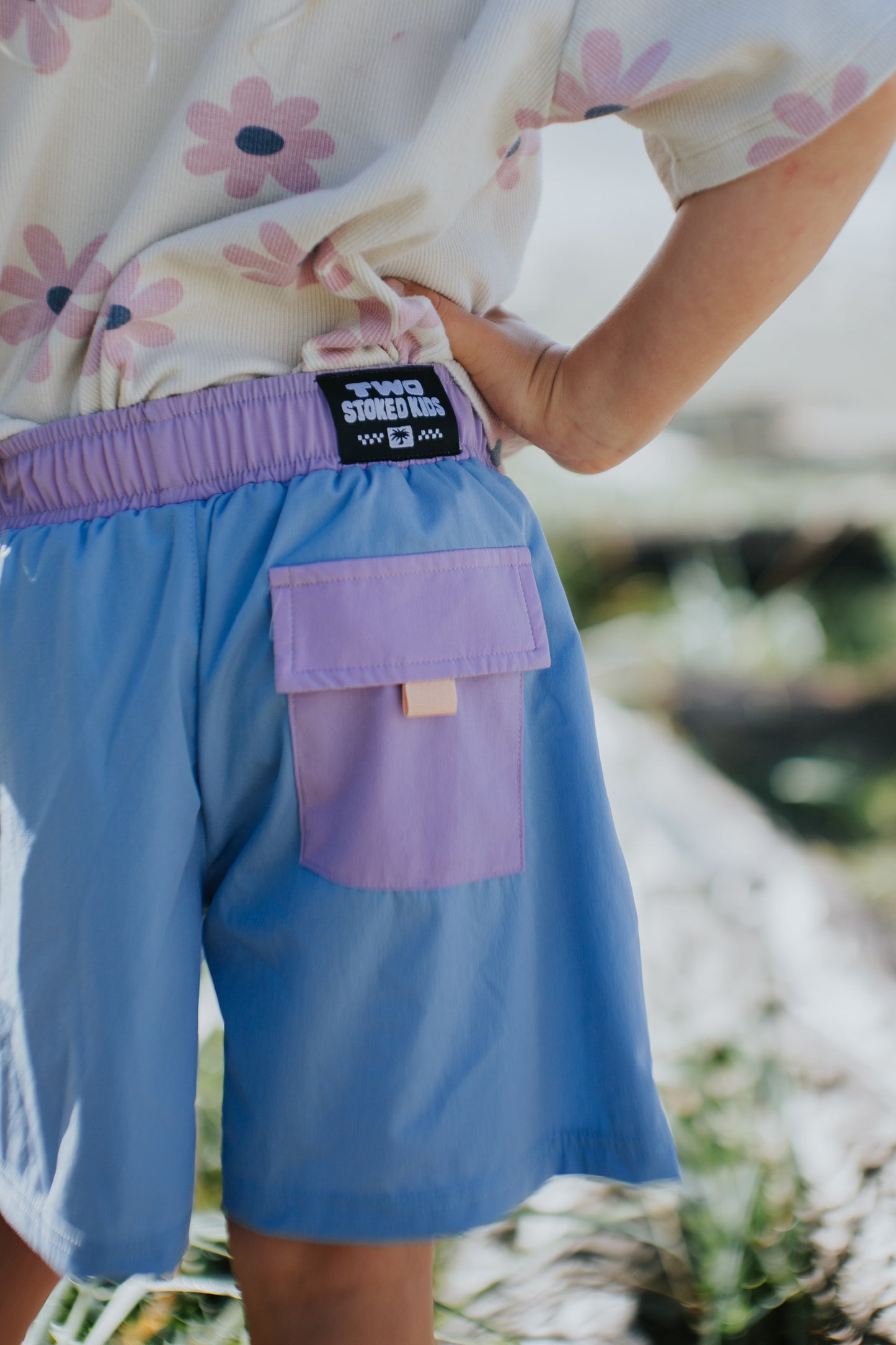 Blue kids trekking shorts with purple pockets designed for outdoor comfort and play