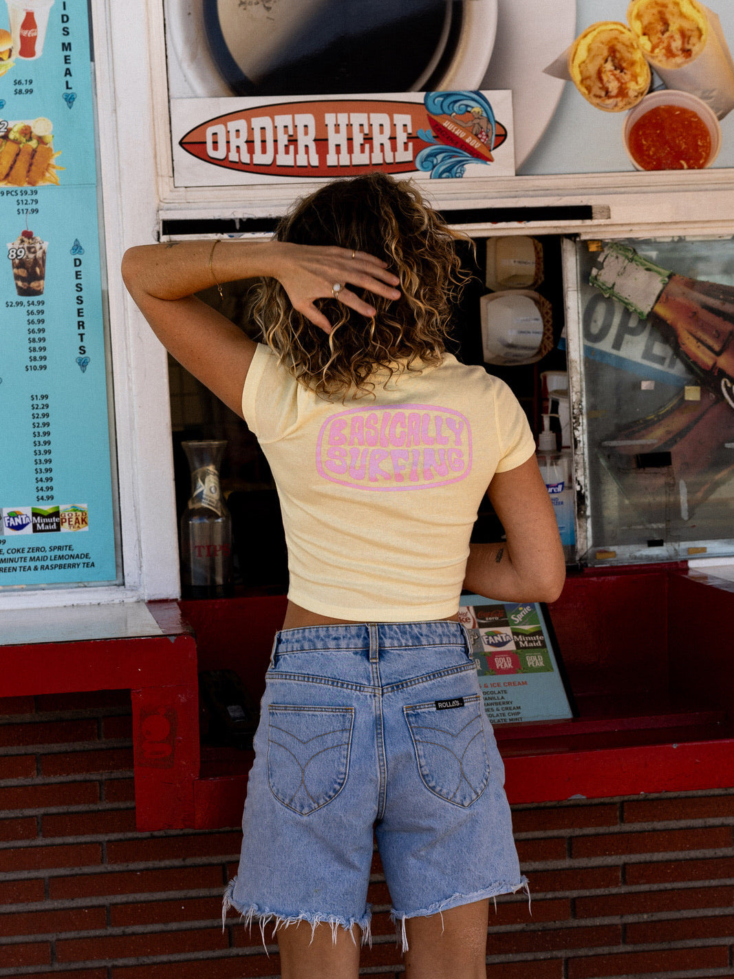 Women’s light yellow cotton baby tee with surf inspired print and summer style