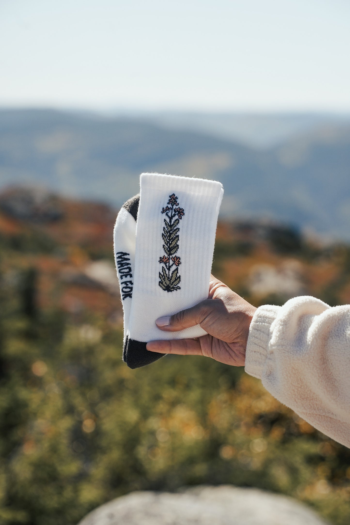 White merino wool crew hiking socks featuring floral and mushroom embroidery