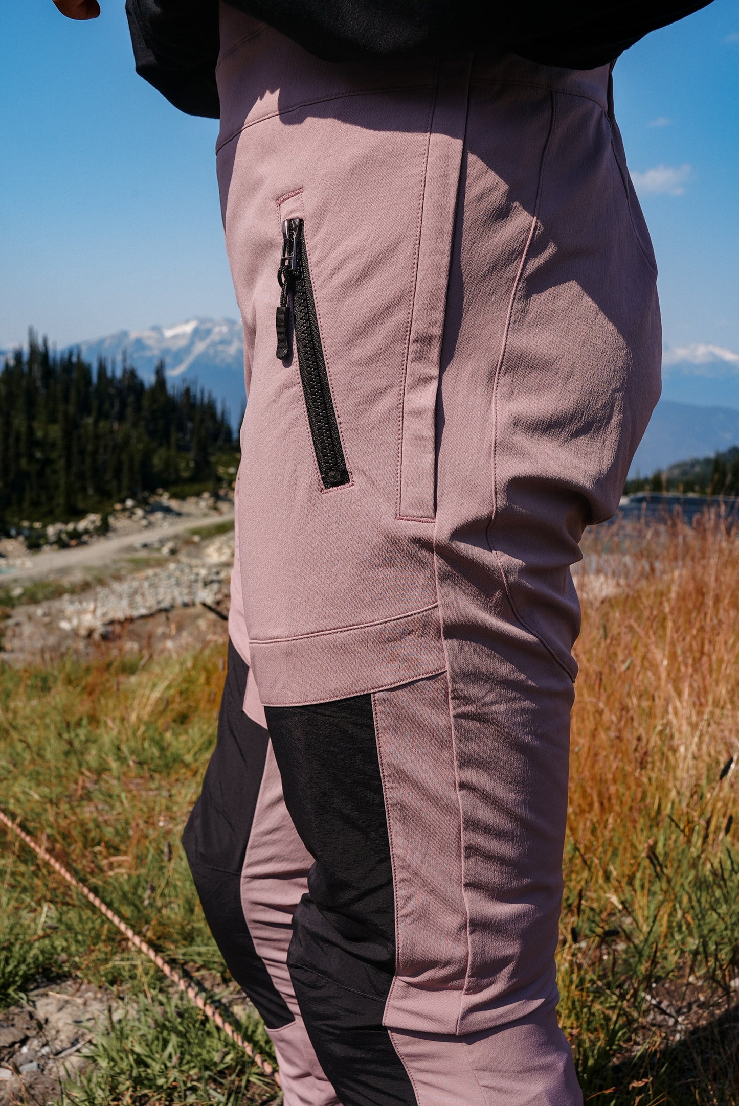 MTB bib for women in dusty pink with breathable material and side zip pockets for storage