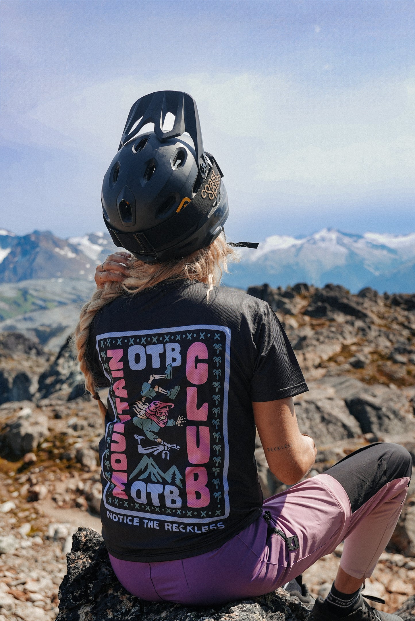 Women wearing a black MTB short sleeve jersey with OTB mountain club graphic print and breathable performance fabric