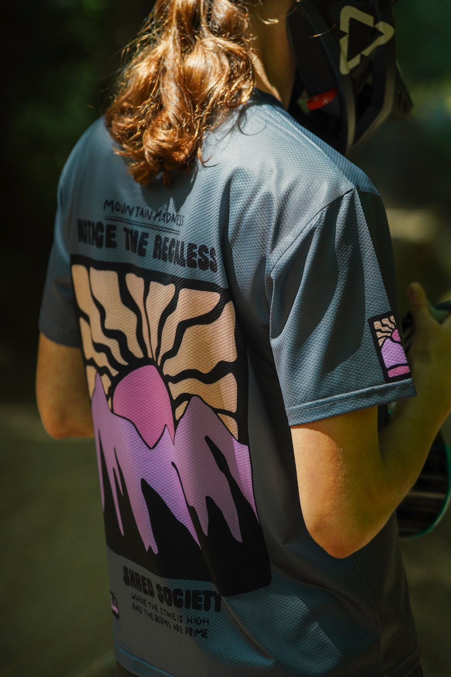 Women wearing a grey MTB short sleeve jersey designed for mountain biking with breathable technical fabric