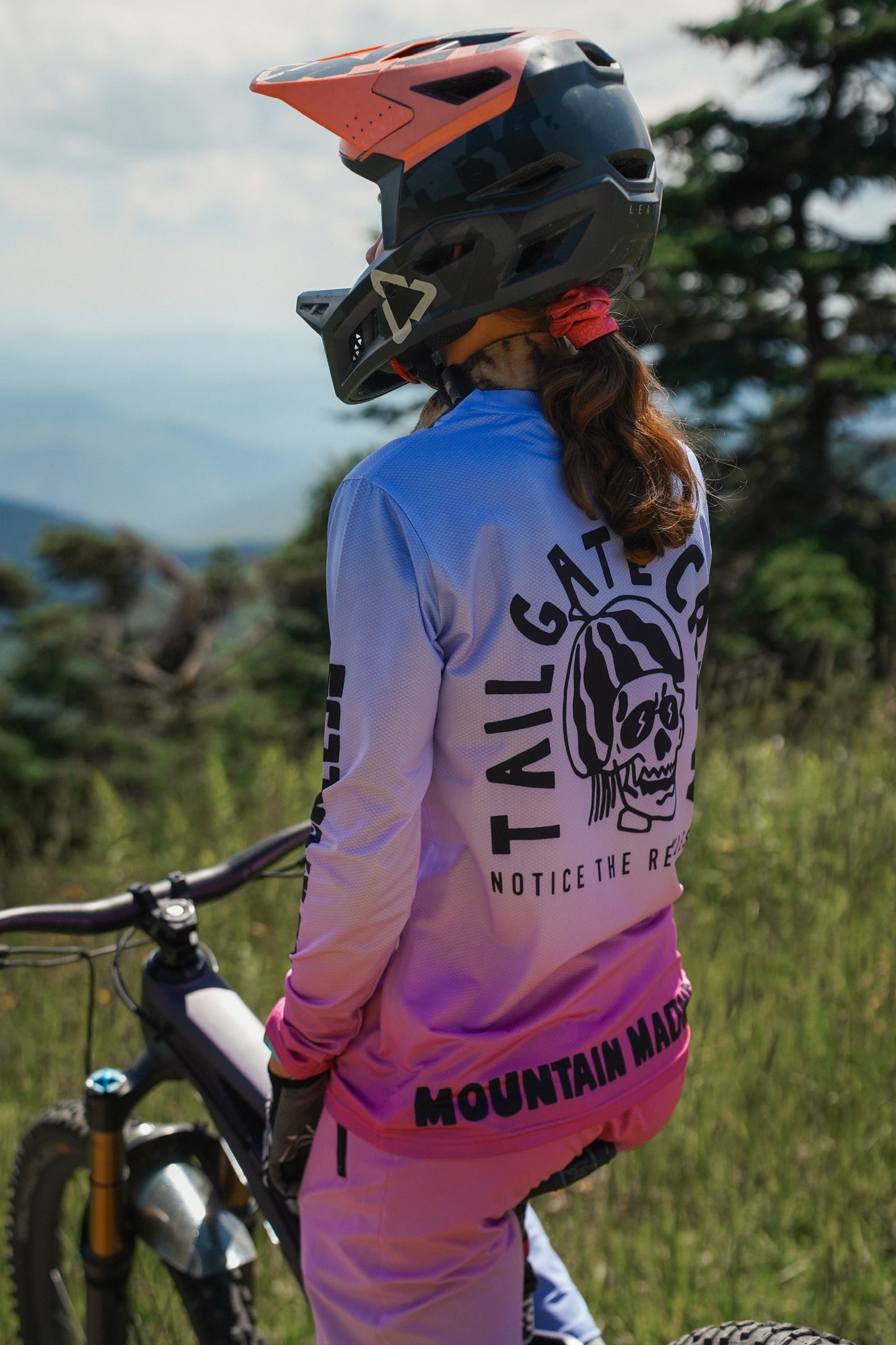 Women wearing a gradient MTB long sleeve jersey in fuchsia to sky blue with breathable performance fabric