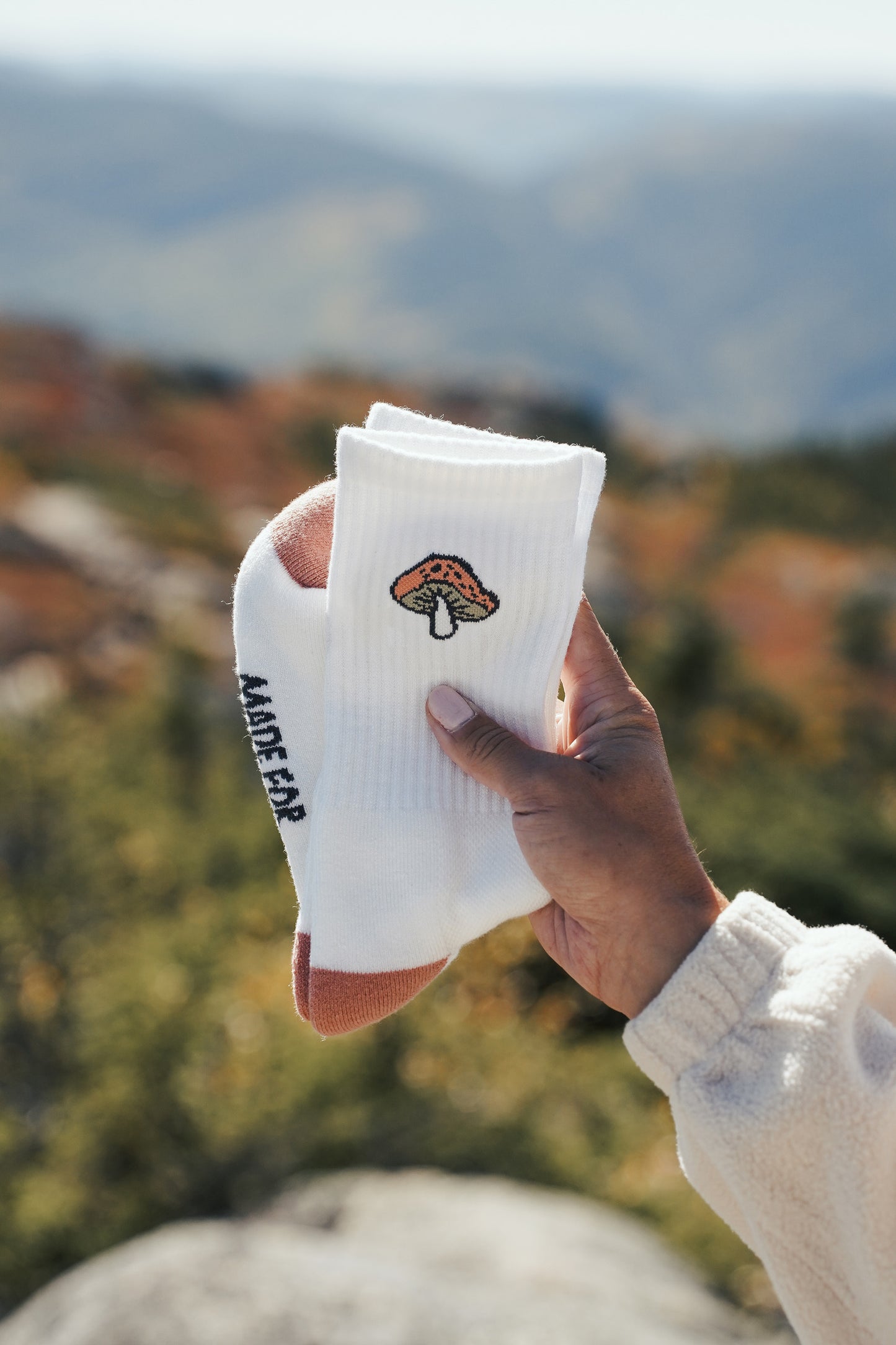 Merino wool crew hiking socks with embroidered wildflower and mushroom motifs