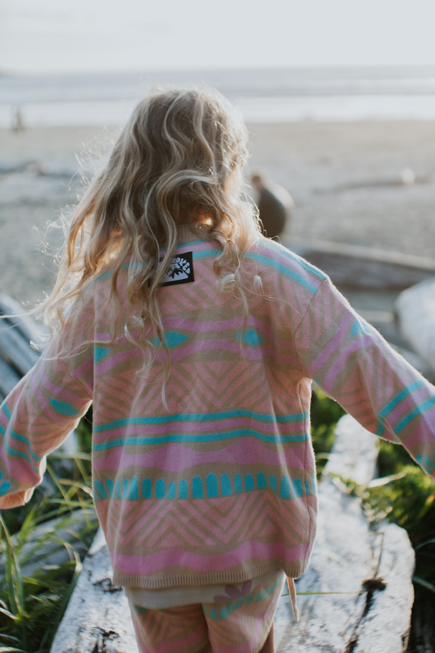 Kids Paradise Island cotton sweater in sand with coral, aqua, and bubblegum pattern for summer wear
