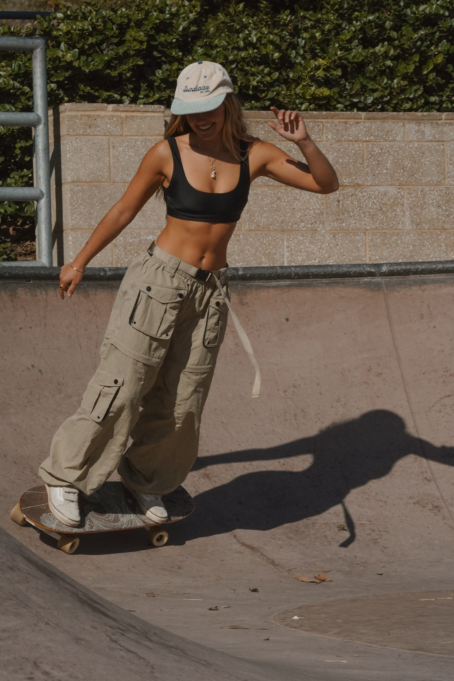 Sand khaki women’s convertible cargo pants with zip-off legs, side release belt, snap cargo pockets and lightweight outdoor design for hiking or skating