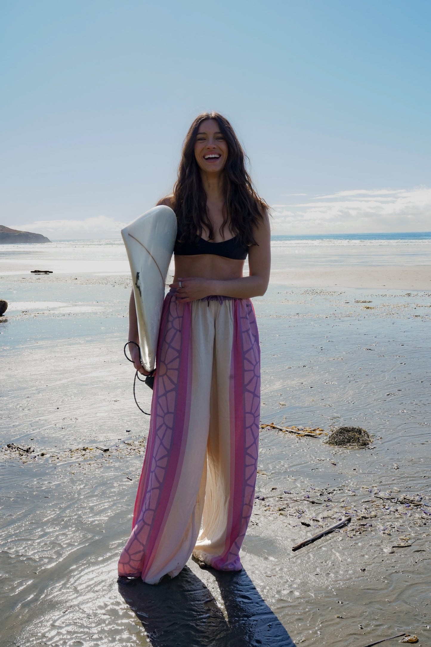 Women’s cotton boho pants with pink, coral, and purple print in a summer surf style