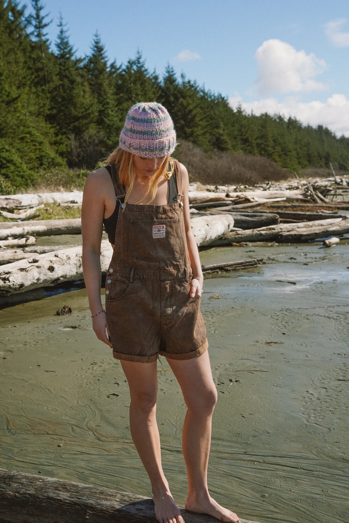 Brown short overalls showing two side pockets and loose silhouette