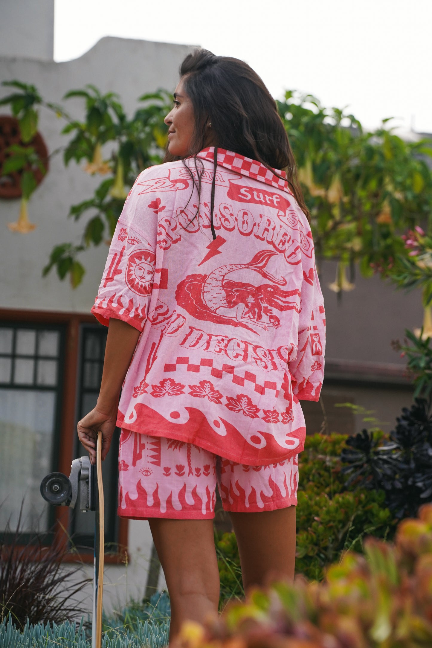 Pink and red linen shirt with a bold woven print, button-front closure and lightweight feel, styled with matching shorts for a laid-back coastal vibe