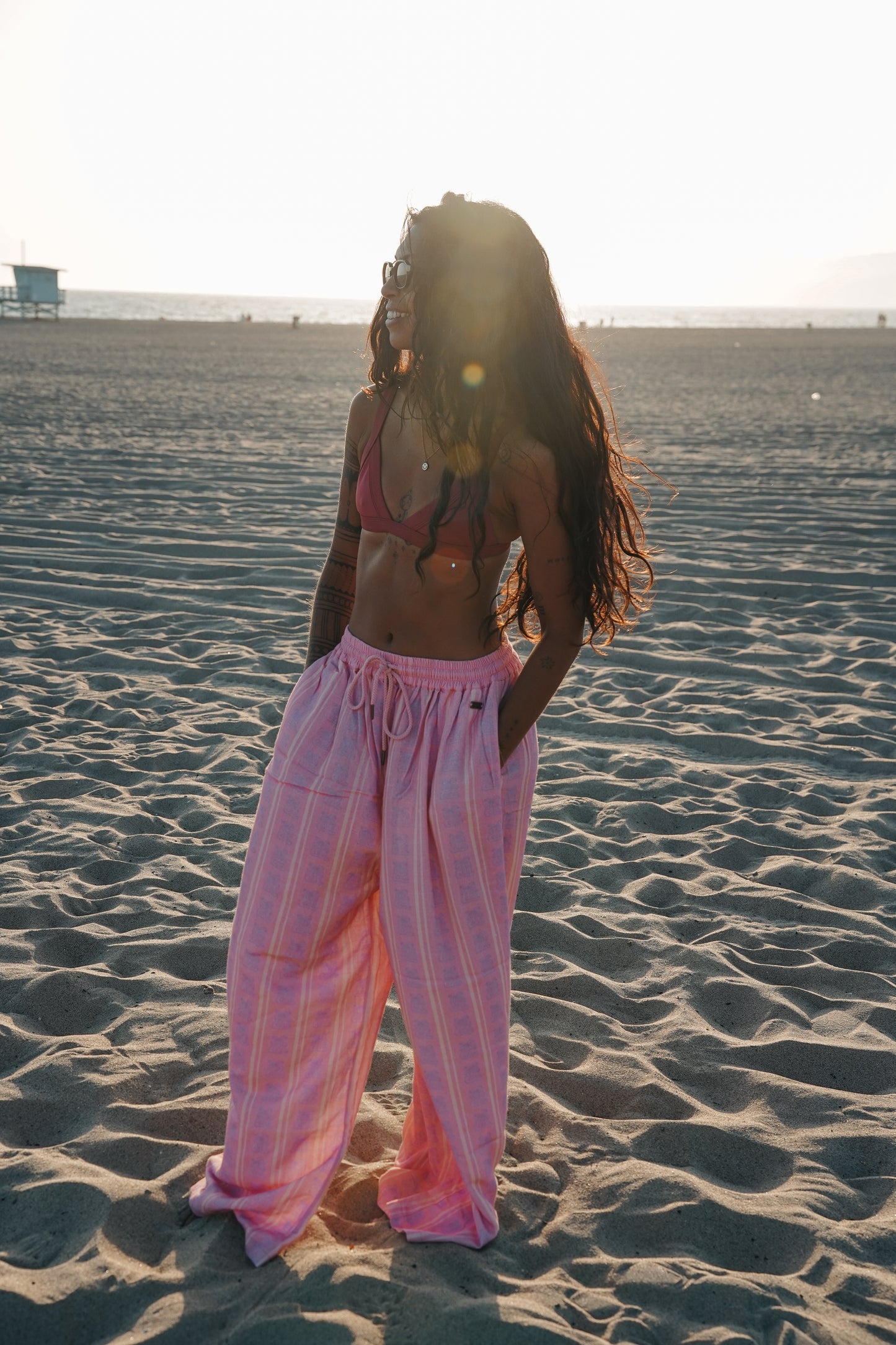 Pink boho linen pants styled for summer with relaxed fit and lightweight fabric