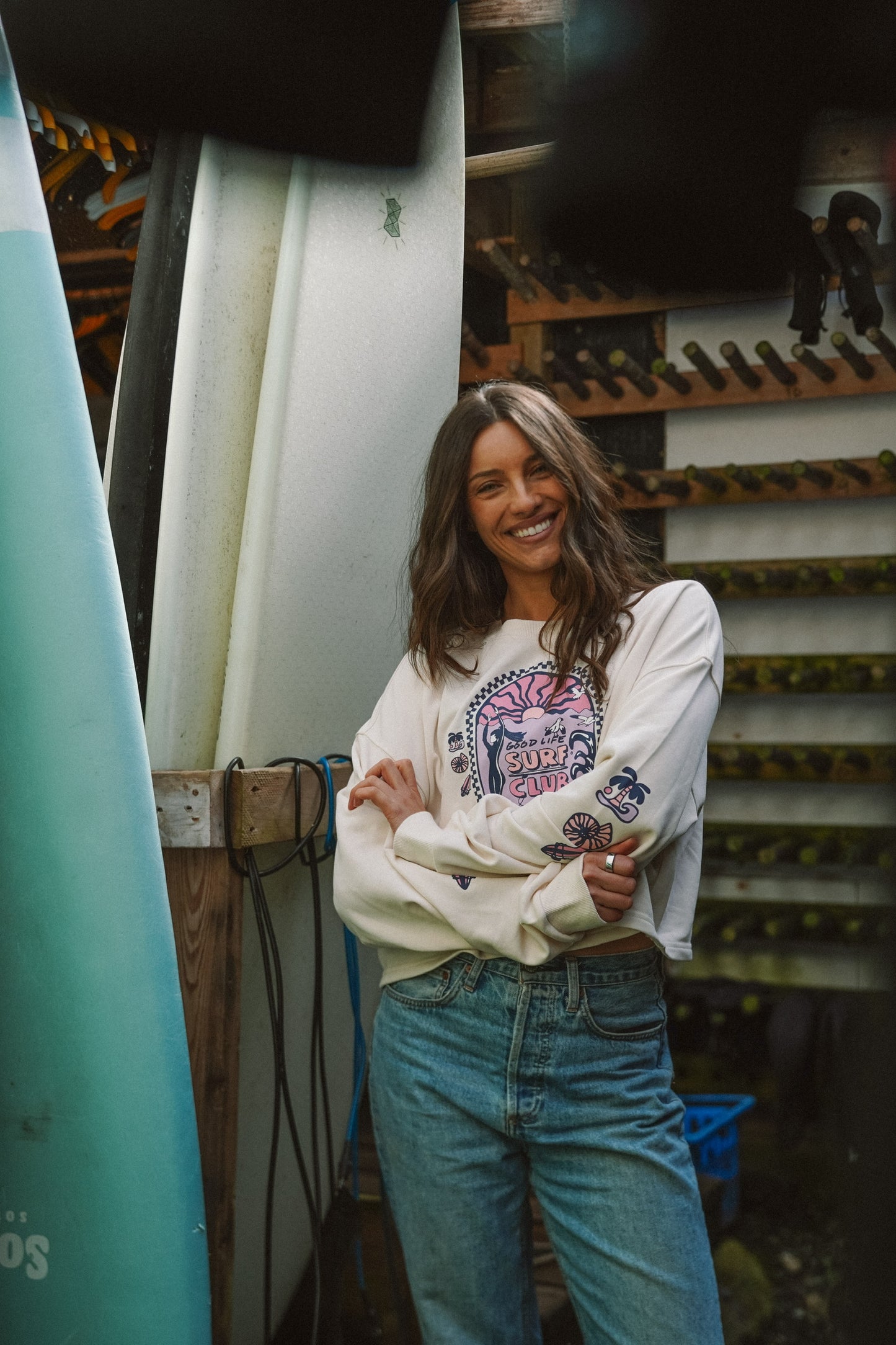 Cropped cotton long sleeve top in off white with graphic print styled for a surf/outdoor outfit
