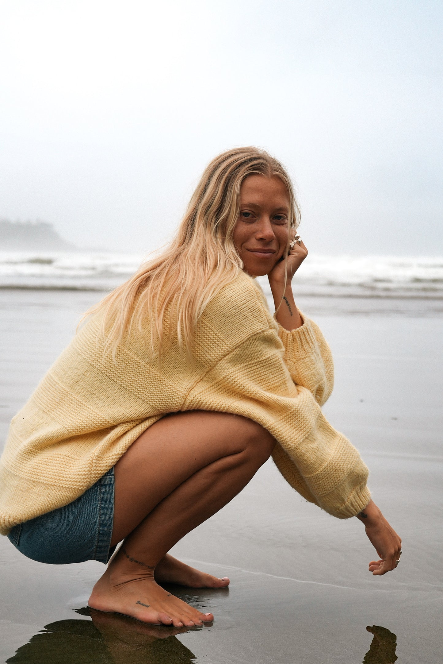 Women’s butter yellow wool sweater featuring oversized sleeves and subtle textured stripes, ideal for cool weather styling