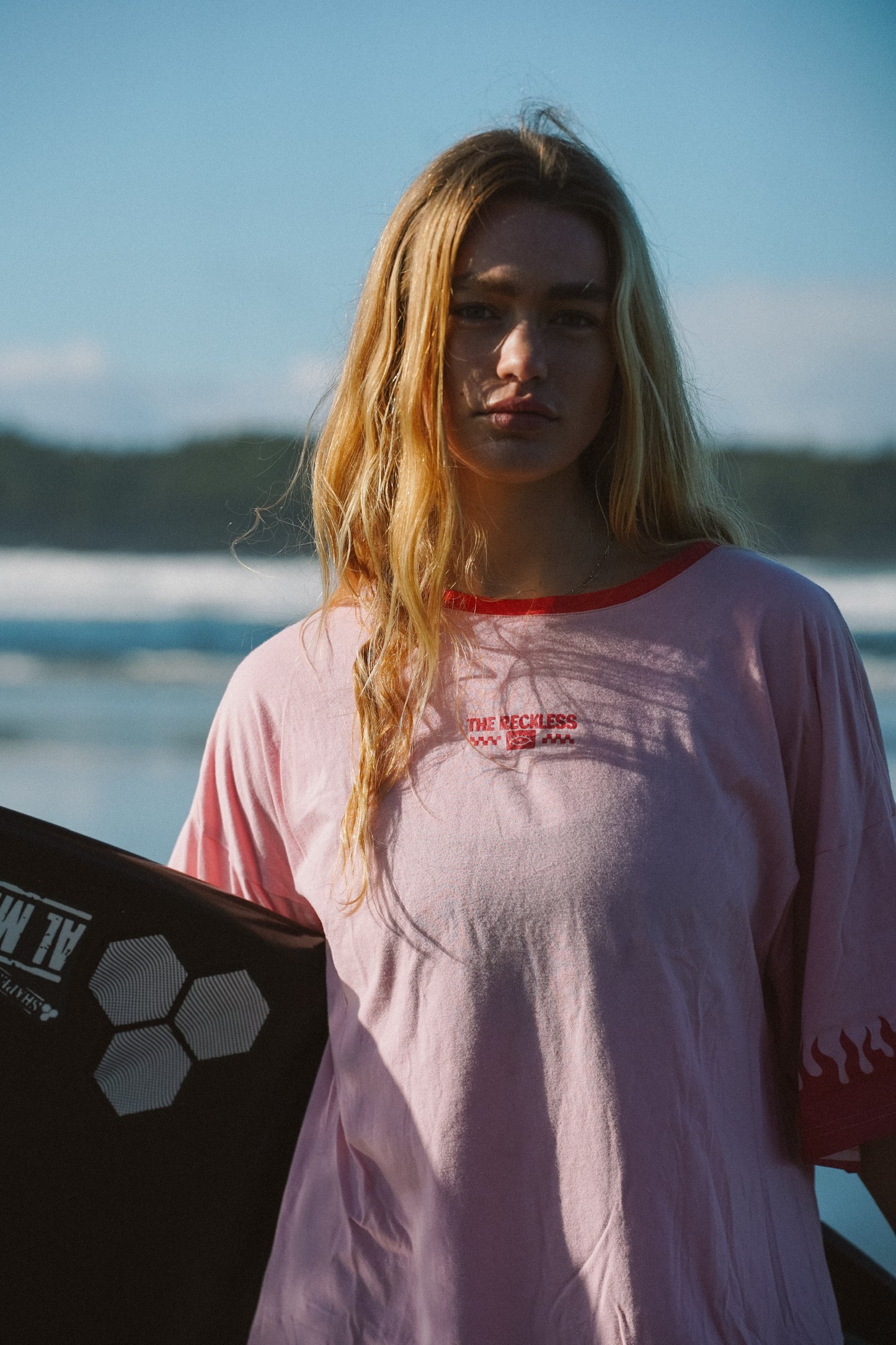 Pink cotton T-shirt dress with front, back, and sleeve prints in a summer style