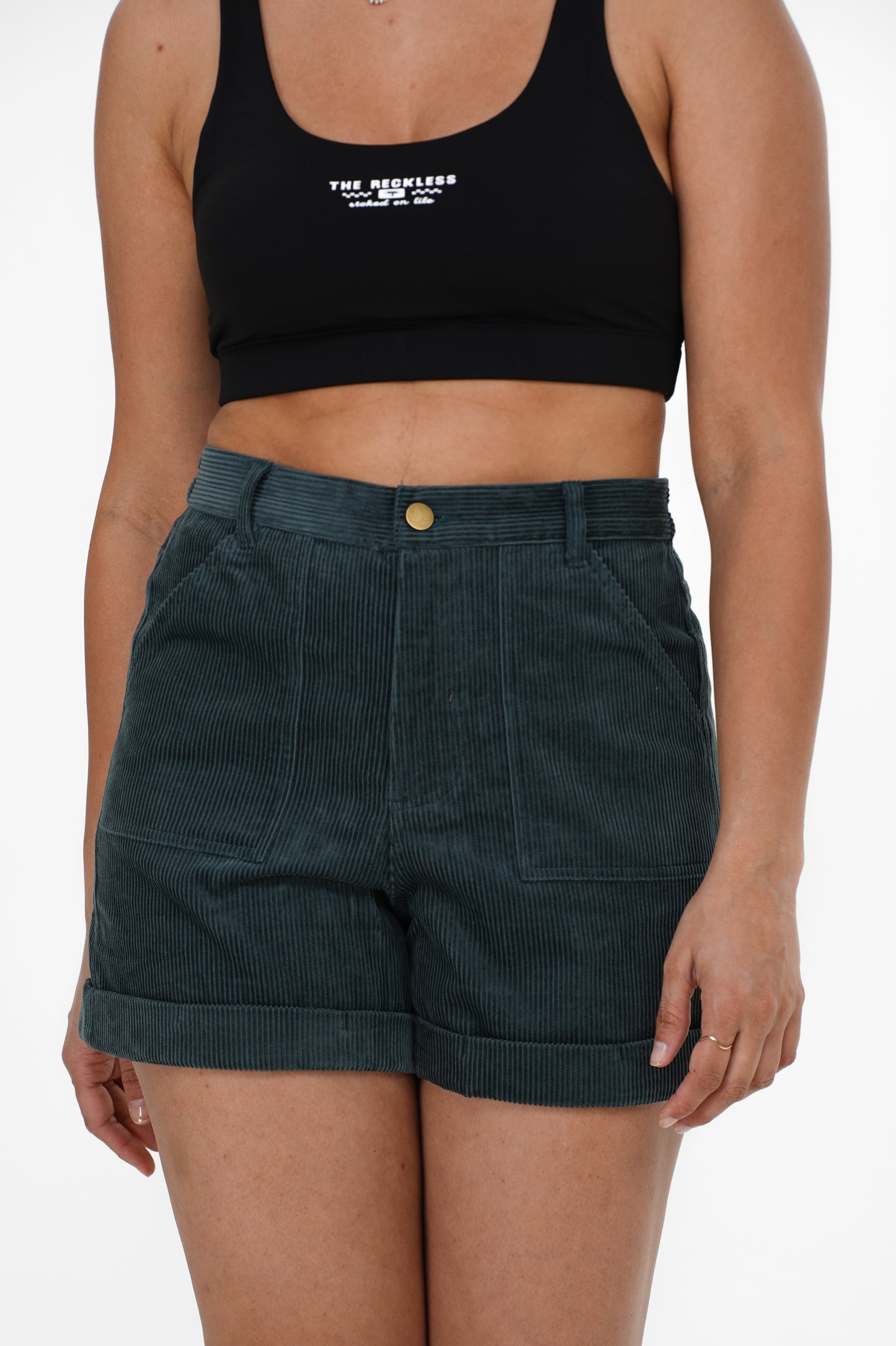 Women’s corduroy shorts with zip fly, button closure, and multiple pockets in dark teal