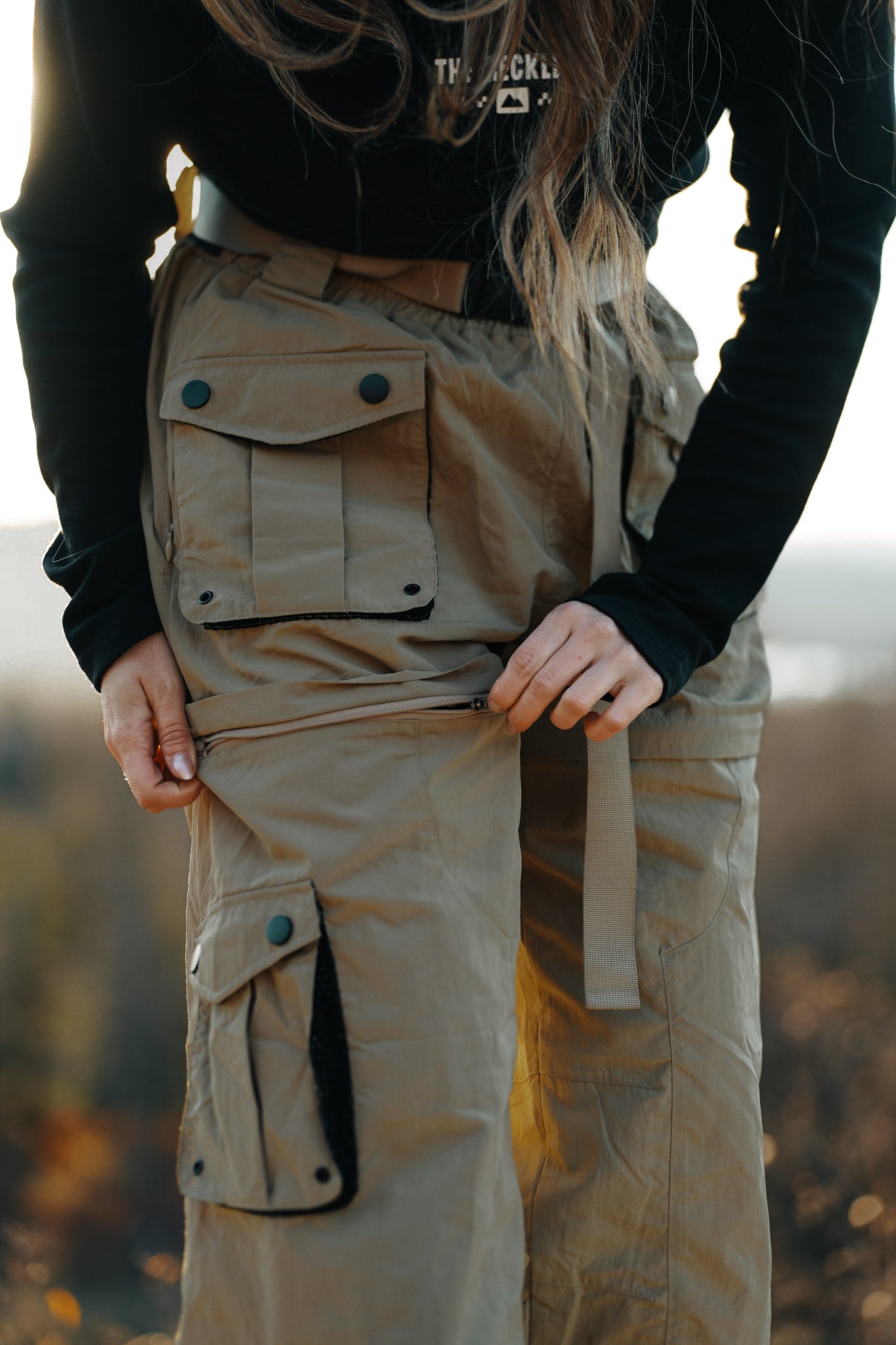 Sand khaki detachable cargo pants for women with ankle zippers, elastic waistband and functional utility pockets perfect for hiking trails or urban skating