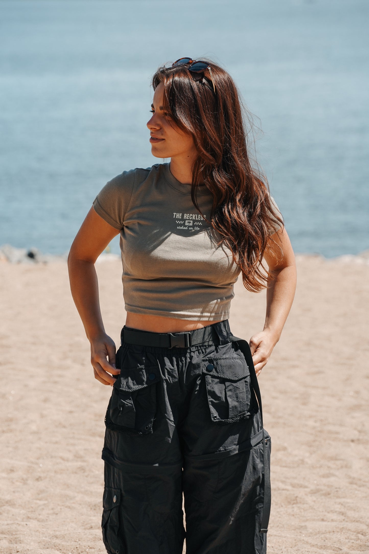 Khaki fitted baby tee with waist-length cut and embroidered front detail, perfect for everyday warm weather outfits