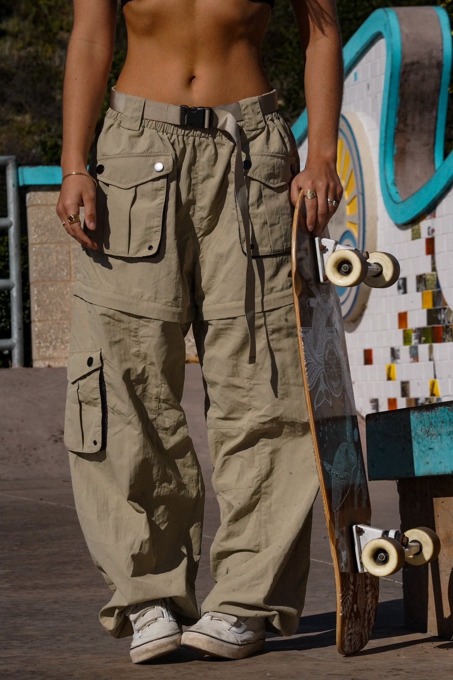 Sand khaki Sahara zip-off cargo pants for women with detachable legs, elastic waistband and multiple utility pockets, ideal for hiking and skatewear